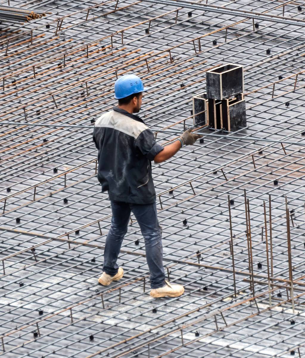 Construction building workers working at the site in a cloudy day
